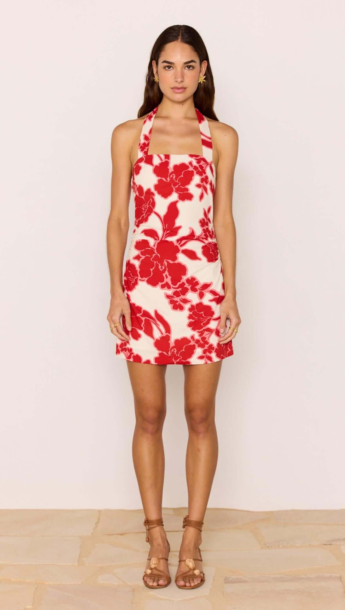 Red &amp; White Floral Linen Blend Halter-Neck Mini Dress modeled by a woman, showcasing a bold floral print on a summer dress.