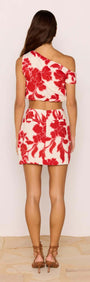 Back view of a model wearing a Red & White Floral Linen Blend Mini Skirt paired with a matching top.