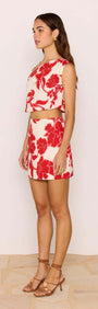 Model wearing a Red & White Floral Linen Blend Mini Skirt with a matching crop top, showcasing a summer-ready outfit.