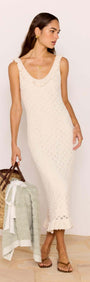 White Pointelle Knit Midi Dress styled as a beach cover-up, featuring a scoop neckline and ruffled hem.