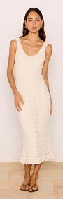 Model wearing a White Pointelle Knit Midi Dress in cream with a scoop neckline and ruffled hem.