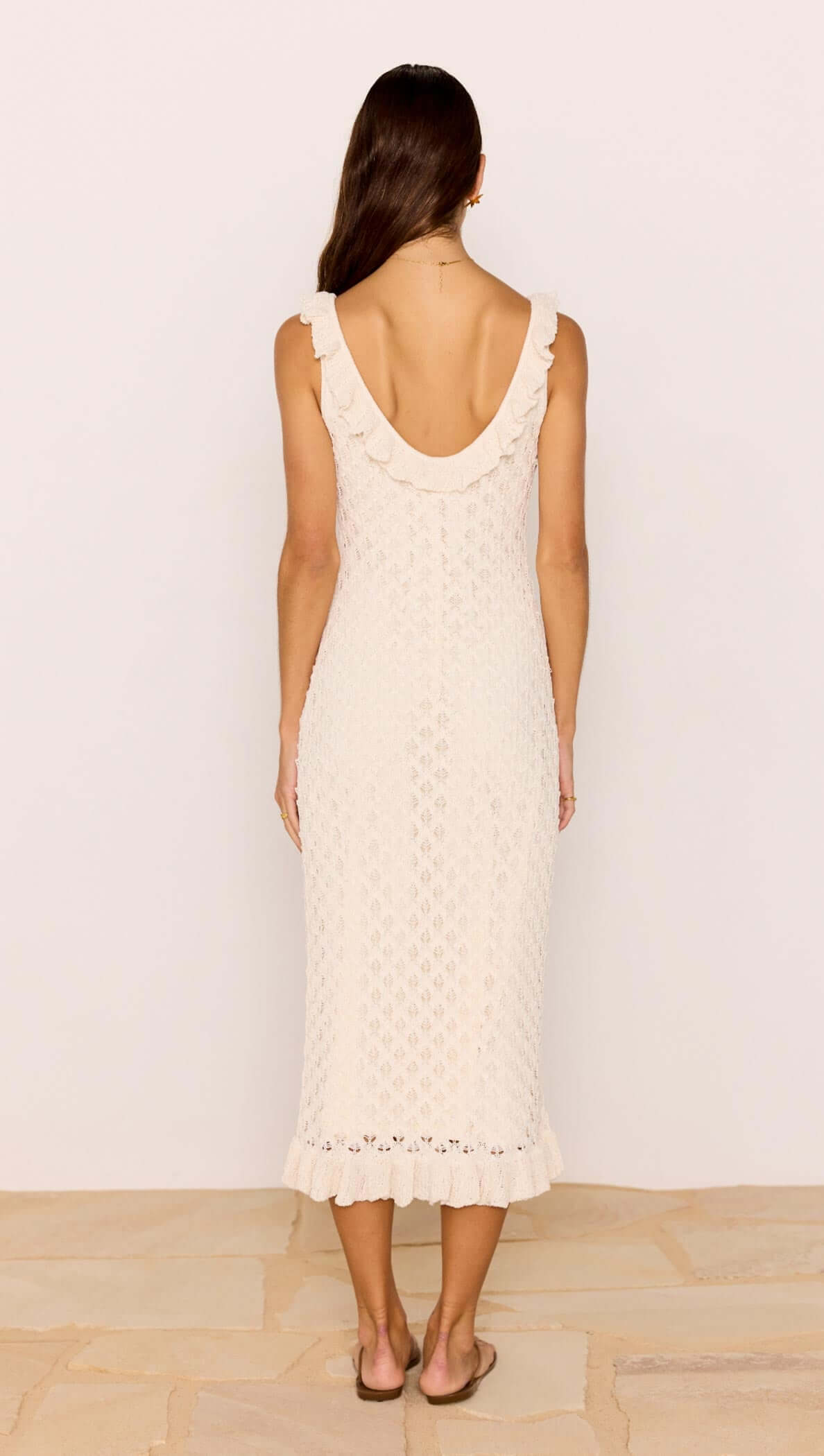 Back view of the White Pointelle Knit Midi Dress featuring a scoop neckline and ruffled hem in a soft cream color.
