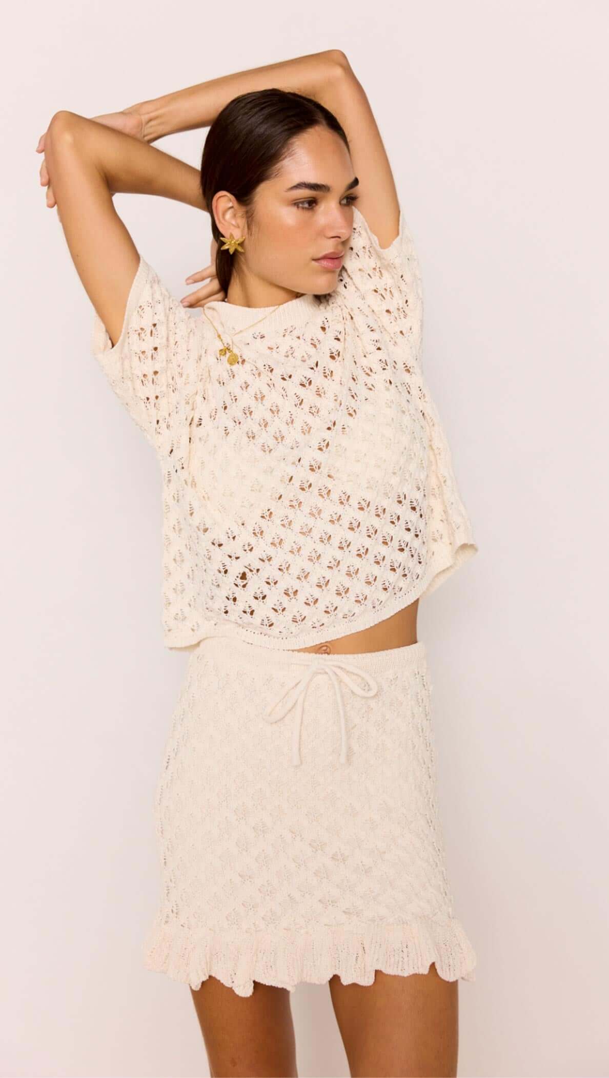 White Pointelle Knit Resort Top styled with matching Sabine Mini Skirt, showcasing a breathable open-knit design in cream.